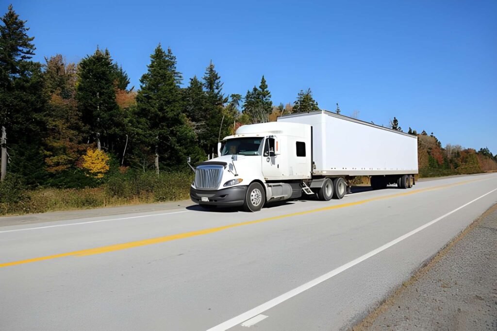 White dry van semi trailer parked on a rural road